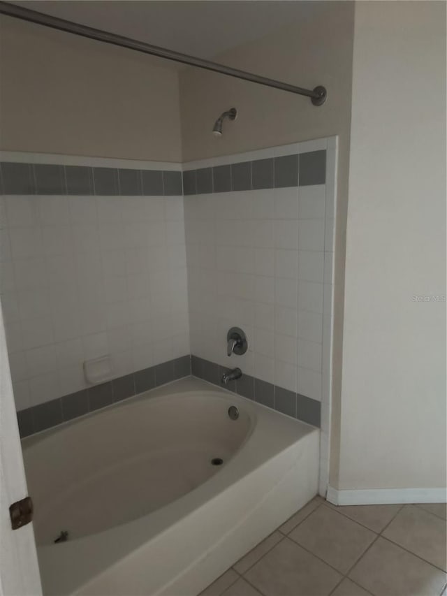 bathroom with tile patterned floors, bathtub / shower combination, and baseboards