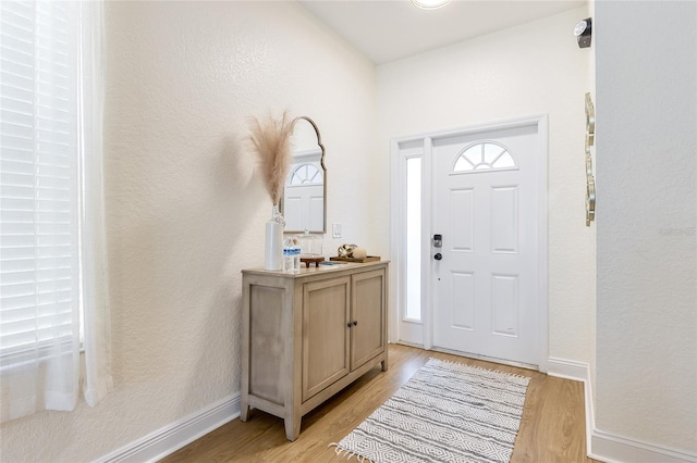 entrance foyer featuring light wood finished floors and baseboards