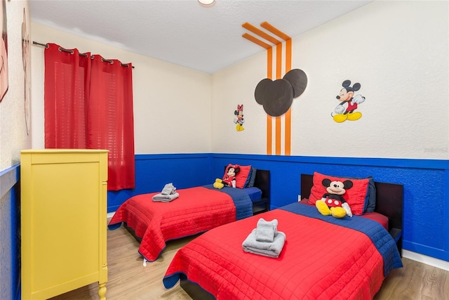 bedroom with baseboards and wood finished floors