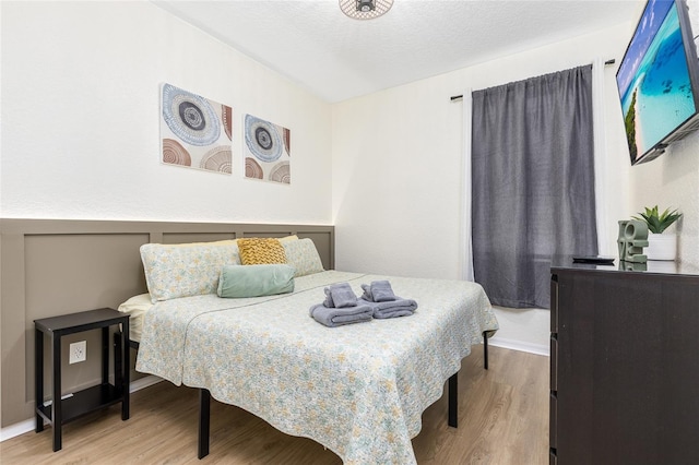 bedroom featuring wood finished floors