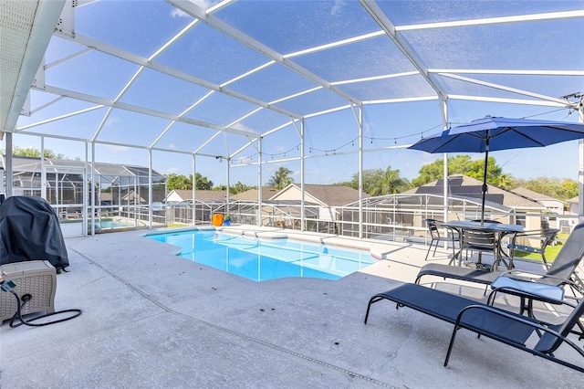 pool featuring a patio area, a lanai, a grill, and fence