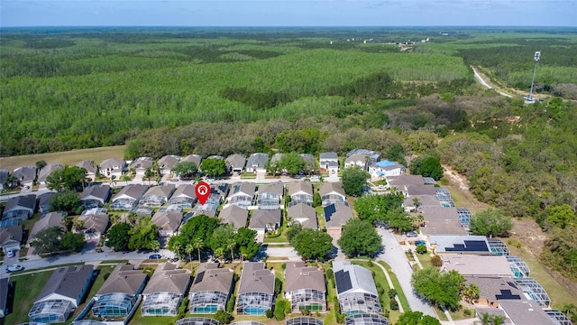 drone / aerial view featuring a residential view and a forest view
