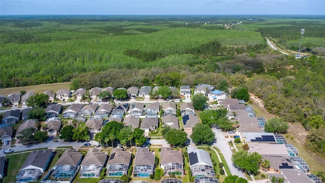 birds eye view of property with a view of trees and a residential view
