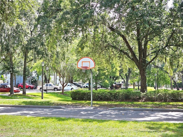 view of sport court featuring community basketball court and a yard