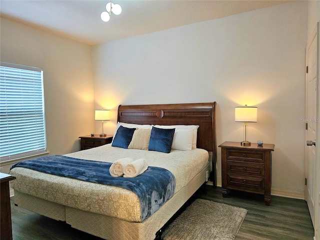 bedroom featuring baseboards and wood finished floors