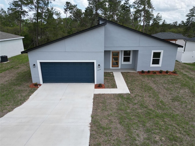 2644 SW 162 Nd Street Rd, Ocala, FL 34473 - view of front facade with a garage, a front lawn, stucco siding, and concrete driveway