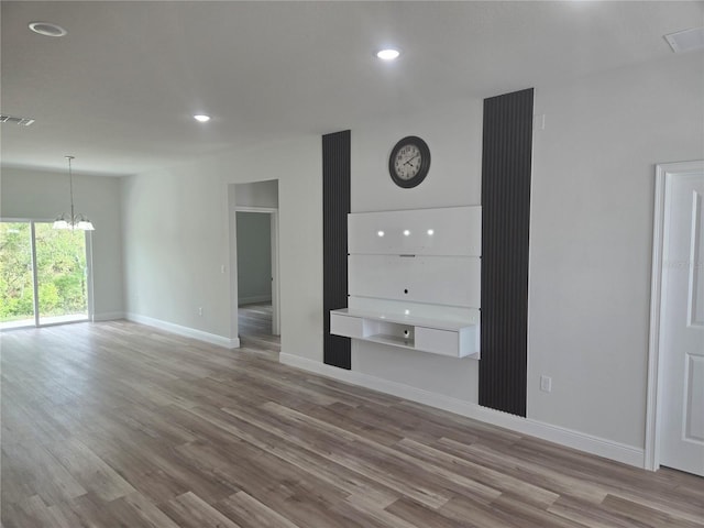 2644 SW 162 Nd Street Rd, Ocala, FL 34473 - unfurnished living room with visible vents, baseboards, a chandelier, recessed lighting, and wood finished floors