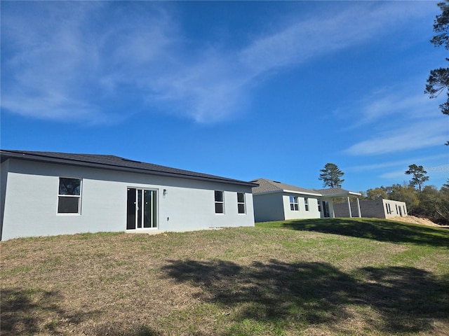 2644 SW 162 Nd Street Rd, Ocala, FL 34473 - rear view of house featuring a yard and stucco siding