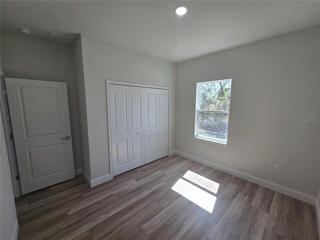 2644 SW 162 Nd Street Rd, Ocala, FL 34473 - unfurnished bedroom featuring a closet, baseboards, and wood finished floors