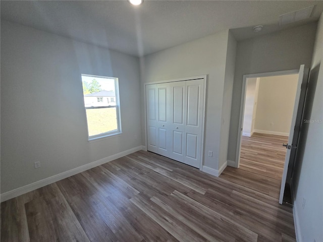 2644 SW 162 Nd Street Rd, Ocala, FL 34473 - unfurnished bedroom with wood finished floors, baseboards, and a closet