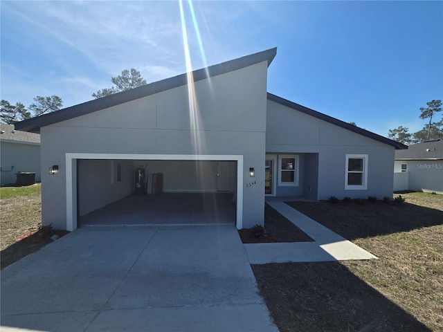 2644 SW 162 Nd Street Rd, Ocala, FL 34473 - view of front facade with an attached garage, concrete driveway, and stucco siding
