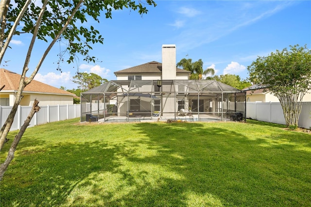 239 Longhirst Loop, Ocoee, FL 34761 - back of house featuring a fenced backyard, a chimney, glass enclosure, and a patio area