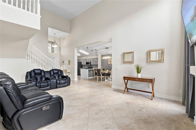 239 Longhirst Loop, Ocoee, FL 34761 - living area with a high ceiling, stairs, and light tile patterned floors