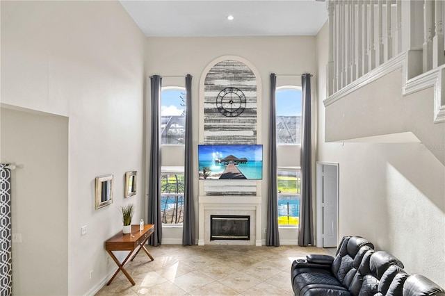 239 Longhirst Loop, Ocoee, FL 34761 - living room with a towering ceiling, plenty of natural light, tile patterned floors, a fireplace, and recessed lighting