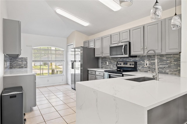 239 Longhirst Loop, Ocoee, FL 34761 - kitchen with stainless steel appliances, gray cabinets, a peninsula, light tile patterned flooring, and decorative backsplash