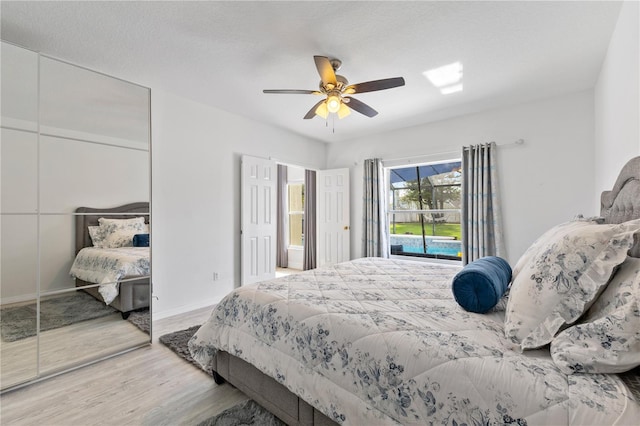 239 Longhirst Loop, Ocoee, FL 34761 - bedroom with wood finished floors, a closet, a ceiling fan, and access to outside