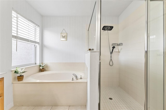 239 Longhirst Loop, Ocoee, FL 34761 - bathroom featuring a shower stall, a garden tub, and tile patterned flooring