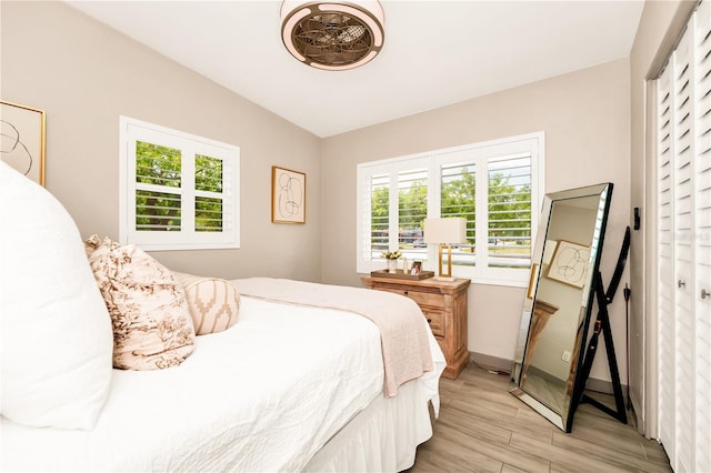bedroom featuring baseboards and light wood-style flooring