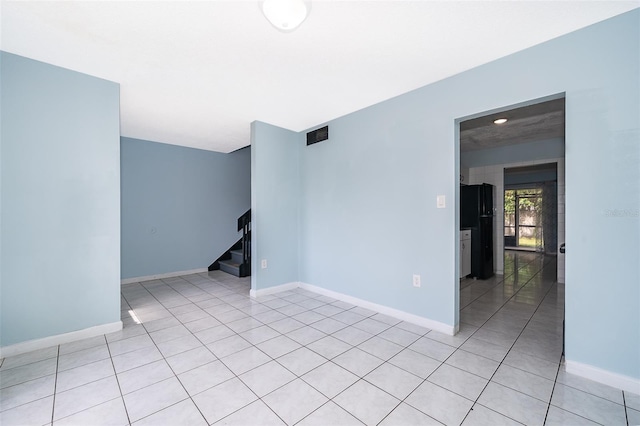 5060 Downing St Unit 6, Orlando, FL 32839 - unfurnished room with stairway, light tile patterned floors, and baseboards