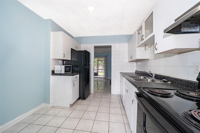 5060 Downing St Unit 6, Orlando, FL 32839 - kitchen featuring black appliances, extractor fan, dark countertops, and light tile patterned flooring