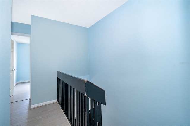 5060 Downing St Unit 6, Orlando, FL 32839 - hallway featuring wood finished floors, an upstairs landing, and baseboards