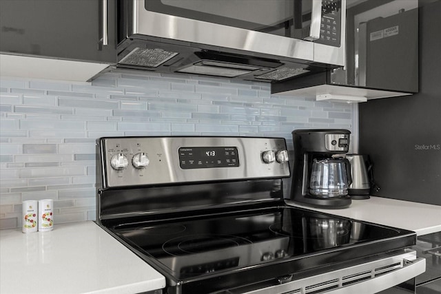 235 Villa Domani Cir, Davenport, FL 33896 - kitchen with stainless steel appliances, backsplash, and light countertops