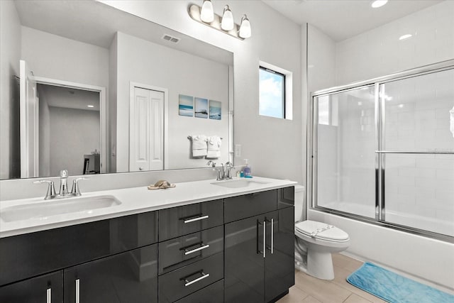235 Villa Domani Cir, Davenport, FL 33896 - full bathroom with double vanity, enclosed tub / shower combo, and tile patterned flooring