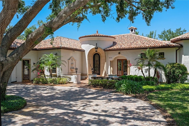 3412 Lilas Ct, Windermere, FL 34786 - mediterranean / spanish house with french doors, a tile roof, and stucco siding