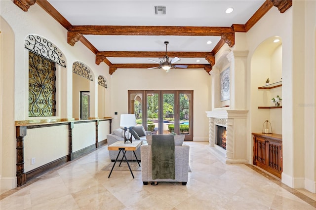 3412 Lilas Ct, Windermere, FL 34786 - living room featuring beamed ceiling, arched walkways, a ceiling fan, visible vents, and a high end fireplace