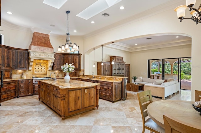 3412 Lilas Ct, Windermere, FL 34786 - kitchen featuring custom exhaust hood, arched walkways, a kitchen island with sink, and a sink