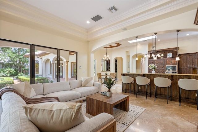 3412 Lilas Ct, Windermere, FL 34786 - living room with arched walkways, a notable chandelier, ornamental molding, and visible vents