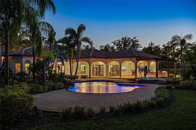 3412 Lilas Ct, Windermere, FL 34786 - rear view of property with an outdoor pool, a patio area, stucco siding, and an in ground hot tub
