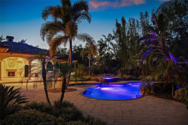 3412 Lilas Ct, Windermere, FL 34786 - pool at dusk with an outdoor pool, an in ground hot tub, and a patio