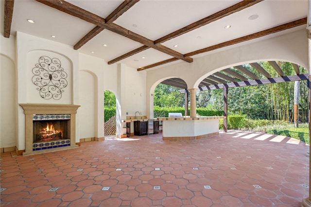 3412 Lilas Ct, Windermere, FL 34786 - view of patio featuring an outdoor kitchen and a warm lit fireplace