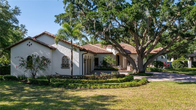 3412 Lilas Ct, Windermere, FL 34786 - mediterranean / spanish-style home featuring stucco siding, a front lawn, and a tile roof