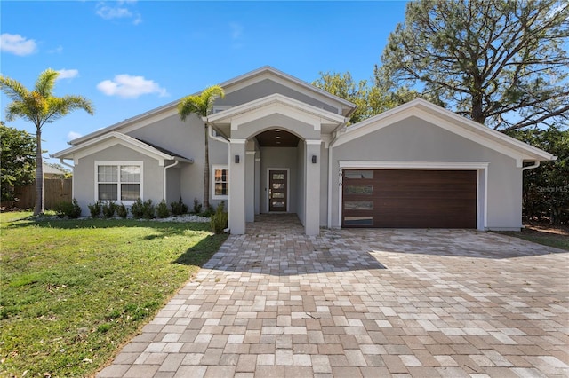 8616 Port Said St, Orlando, FL 32817 - view of front of property featuring an attached garage, stucco siding, decorative driveway, and a front lawn