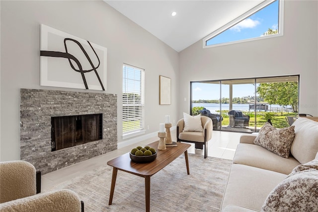 8616 Port Said St, Orlando, FL 32817 - living area featuring high vaulted ceiling, recessed lighting, a fireplace, light tile patterned floors, and a water view