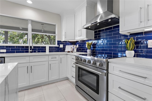 8616 Port Said St, Orlando, FL 32817 - kitchen featuring backsplash, wall chimney exhaust hood, and stainless steel range with electric stovetop