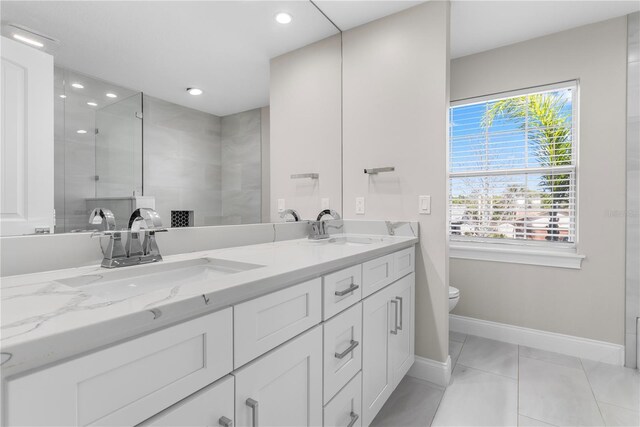 8616 Port Said St, Orlando, FL 32817 - bathroom with double vanity, a tile shower, a sink, and toilet