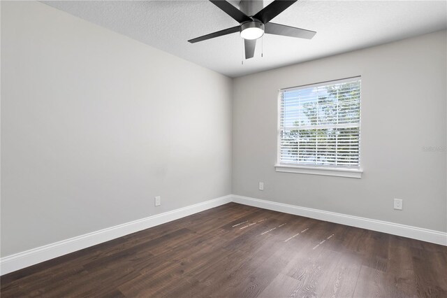 8616 Port Said St, Orlando, FL 32817 - unfurnished room featuring dark wood-type flooring, baseboards, ceiling fan, and a textured ceiling