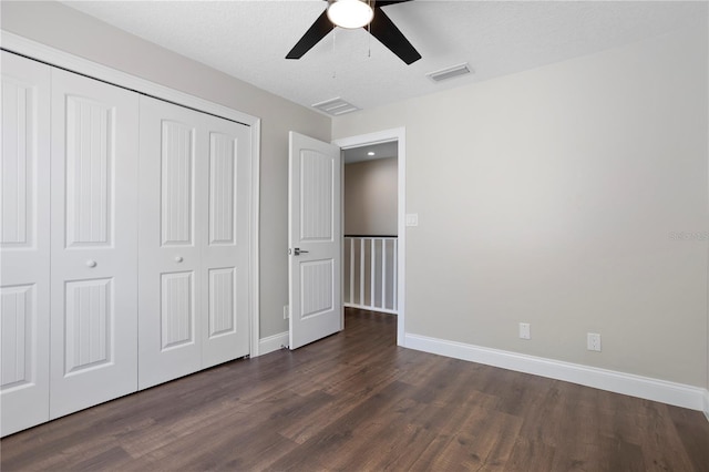 8616 Port Said St, Orlando, FL 32817 - unfurnished bedroom featuring a closet, dark wood-style flooring, baseboards, and visible vents