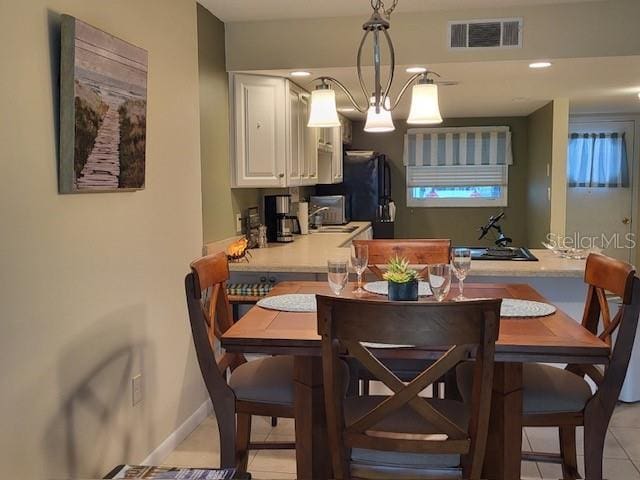 325 N Causeway Unit D104, New Smyrna Beach, FL 32169 - dining space with baseboards, visible vents, and light tile patterned floors