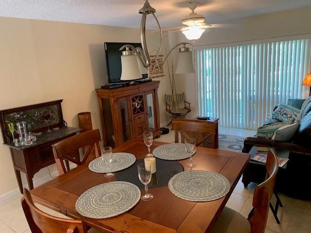 325 N Causeway Unit D104, New Smyrna Beach, FL 32169 - dining room with a ceiling fan and tile patterned flooring