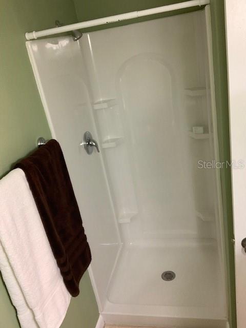 325 N Causeway Unit D104, New Smyrna Beach, FL 32169 - bathroom featuring a stall shower