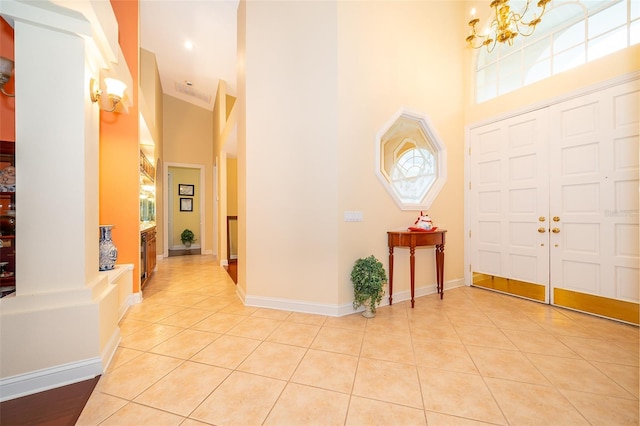1709 Iverness Ct, Longwood, FL 32779 - entryway featuring light tile patterned floors, a towering ceiling, a notable chandelier, and baseboards