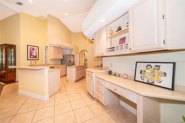 1709 Iverness Ct, Longwood, FL 32779 - kitchen with light countertops, a peninsula, stainless steel refrigerator with ice dispenser, built in study area, and light tile patterned floors