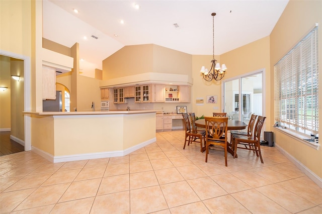 1709 Iverness Ct, Longwood, FL 32779 - dining room with baseboards, high vaulted ceiling, an inviting chandelier, and light tile patterned floors