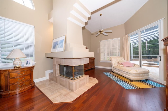 1709 Iverness Ct, Longwood, FL 32779 - living area featuring high vaulted ceiling, a tiled fireplace, wood finished floors, and a ceiling fan