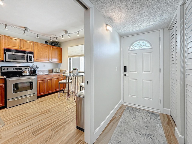 1581 Gulf Blvd Unit 102N, Clearwater Beach, FL 33767 - foyer with light wood-type flooring, plenty of natural light, and baseboards