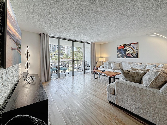 1581 Gulf Blvd Unit 102N, Clearwater Beach, FL 33767 - living area with expansive windows, a textured ceiling, and wood finished floors